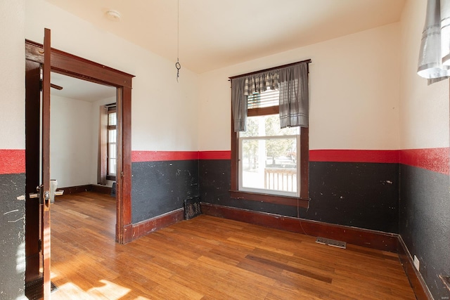 unfurnished room with wood-type flooring