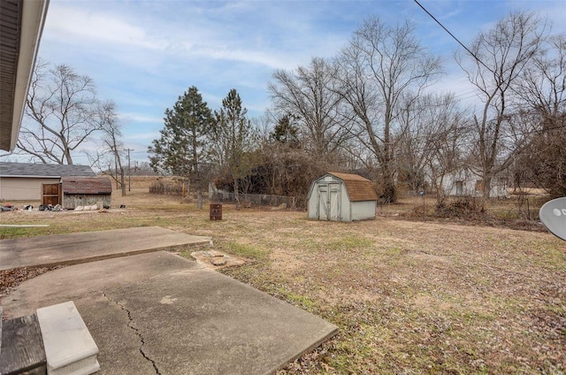 view of yard with a storage shed and a patio