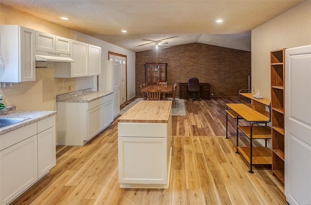 kitchen featuring wood counters, white cabinetry, light hardwood / wood-style flooring, and a kitchen island