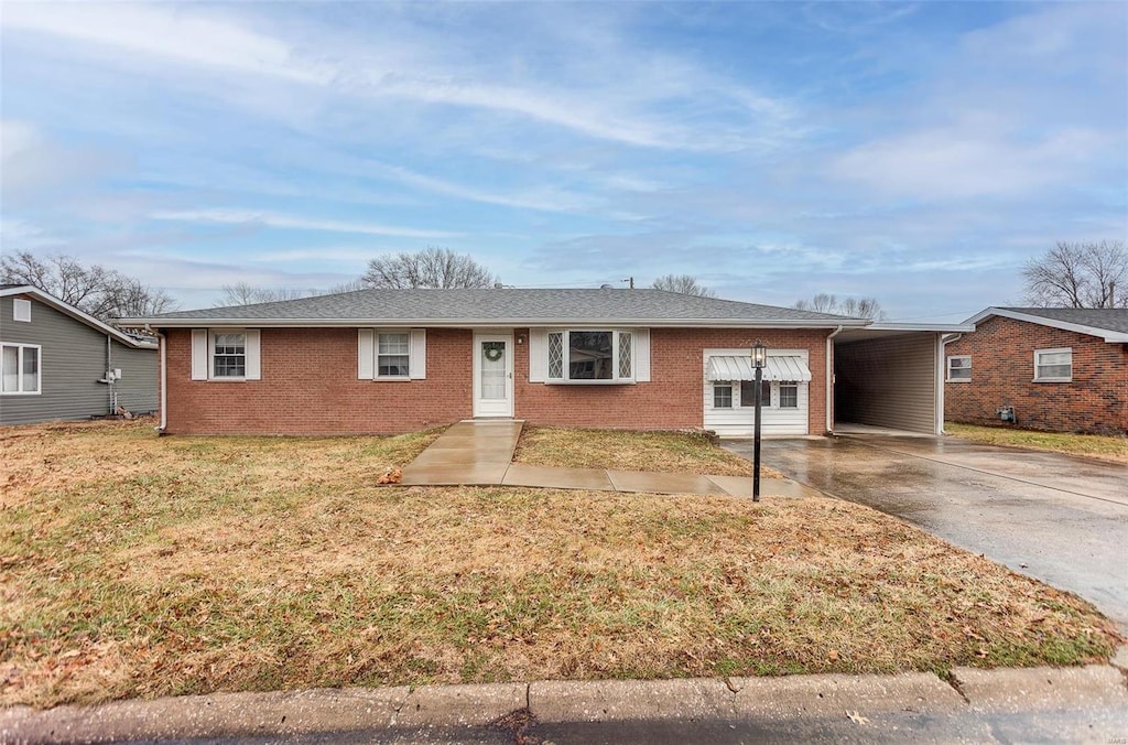 ranch-style house featuring a carport and a front lawn