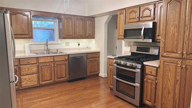 kitchen featuring sink, light hardwood / wood-style flooring, and stainless steel appliances