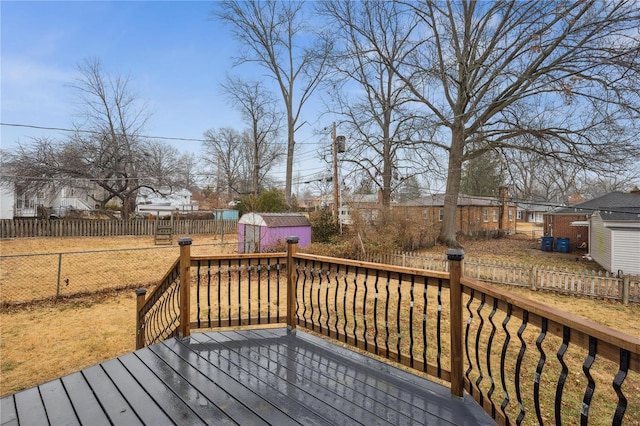 wooden deck with a storage shed