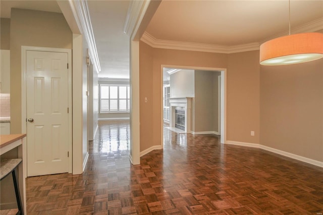 unfurnished dining area featuring ornamental molding, a fireplace, and dark parquet floors