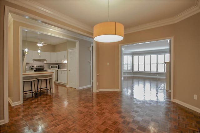 interior space featuring dark parquet flooring and ornamental molding