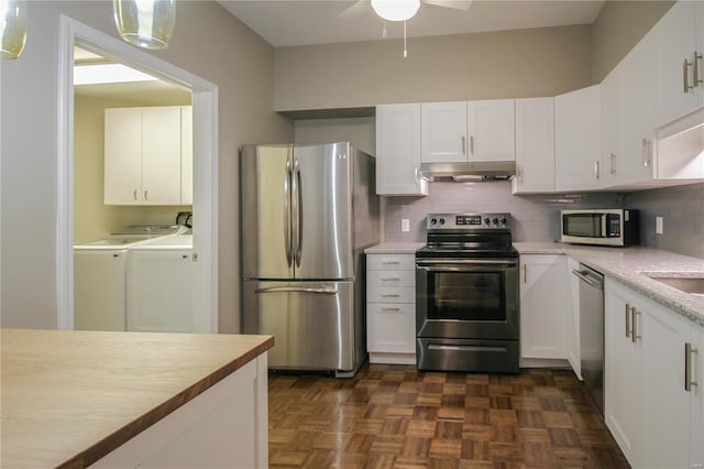 kitchen featuring white cabinetry, independent washer and dryer, stainless steel appliances, and dark parquet flooring