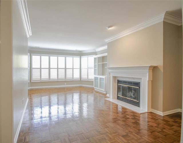 unfurnished living room featuring parquet floors, crown molding, and a fireplace