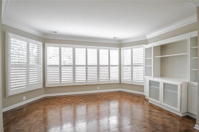 spare room with dark parquet flooring and crown molding