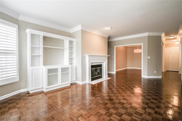 unfurnished living room with crown molding, a fireplace, and dark parquet floors