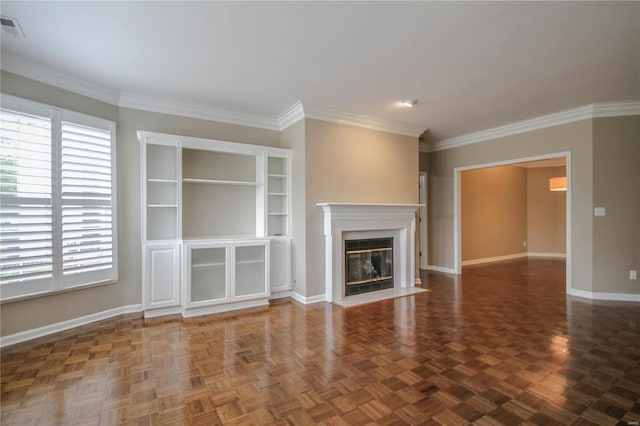 unfurnished living room with ornamental molding, a high end fireplace, and dark parquet floors