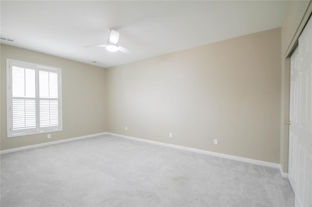 unfurnished room featuring light colored carpet and ceiling fan