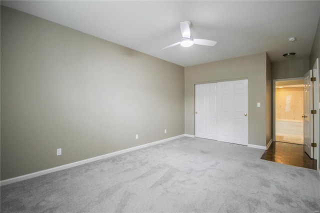 unfurnished bedroom featuring carpet floors, a closet, and ceiling fan