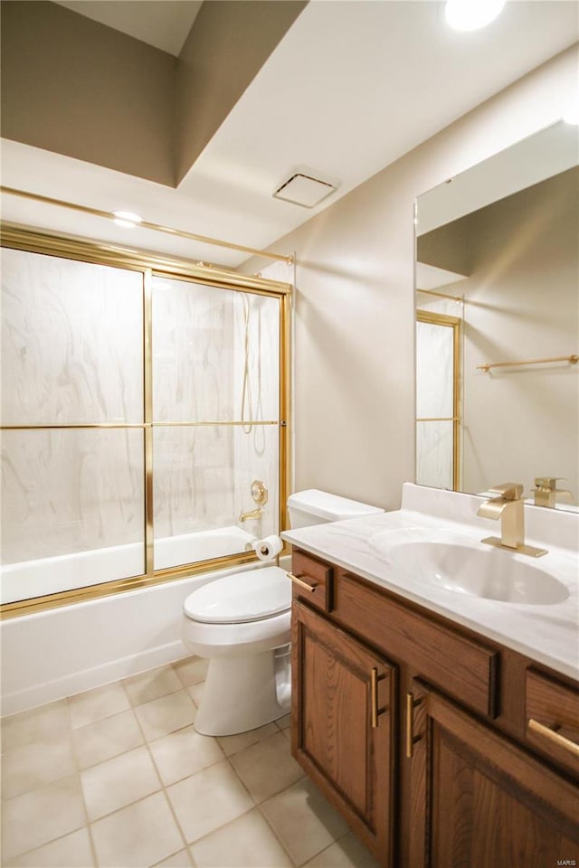 full bathroom with enclosed tub / shower combo, vanity, tile patterned floors, and toilet