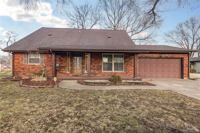 ranch-style home with a garage, a front lawn, and covered porch