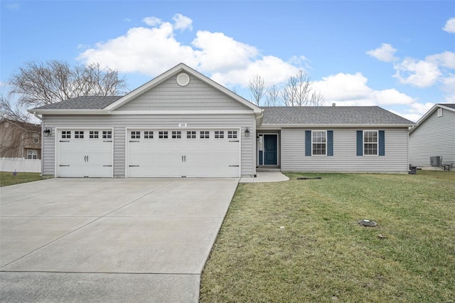 single story home with a front lawn, central AC, driveway, and an attached garage