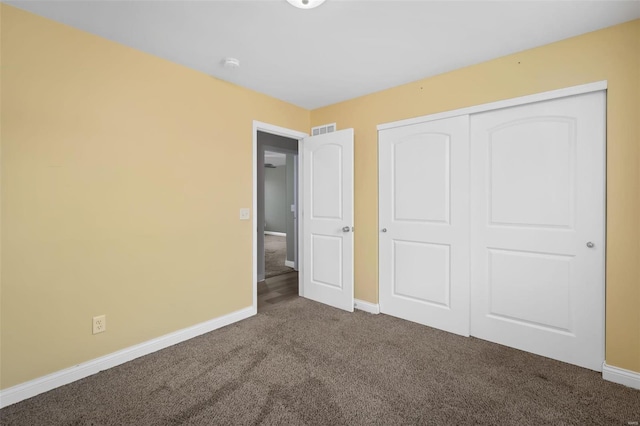 unfurnished bedroom featuring a closet, baseboards, visible vents, and carpet flooring