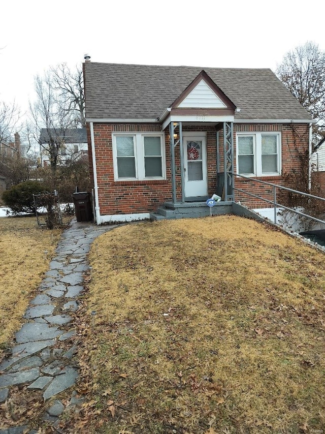 bungalow-style house featuring a front lawn