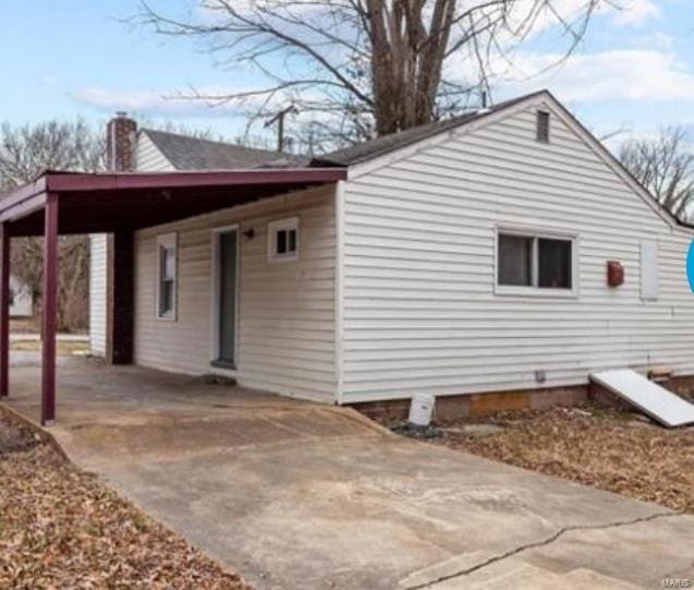 view of property exterior featuring a carport