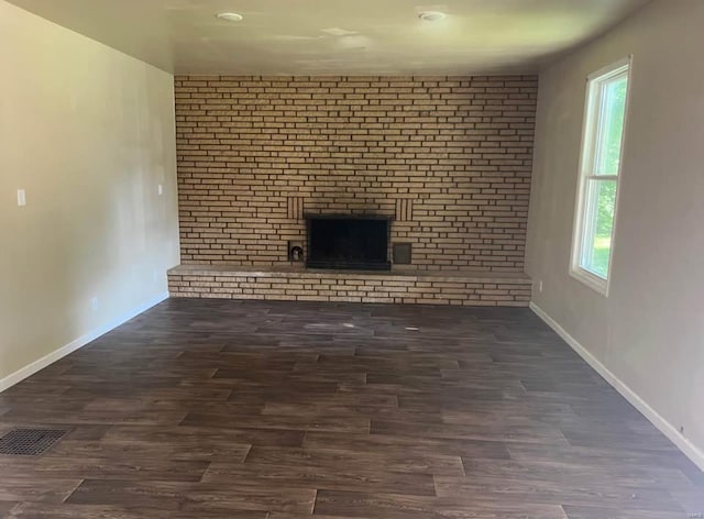 unfurnished living room with dark hardwood / wood-style flooring