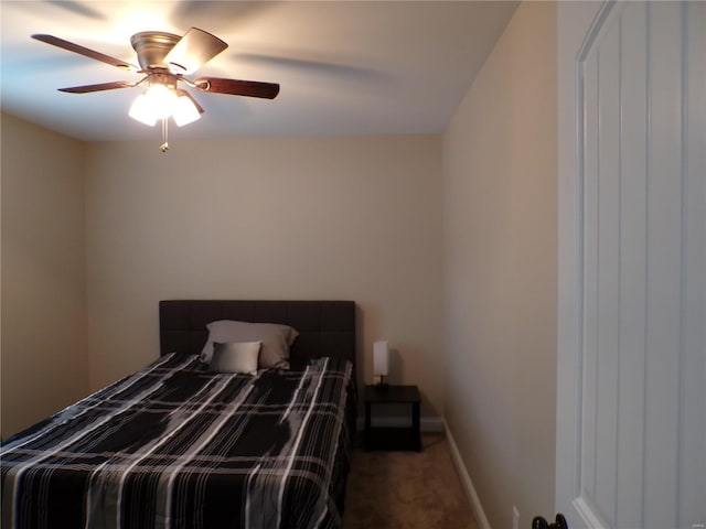 bedroom with ceiling fan and dark colored carpet