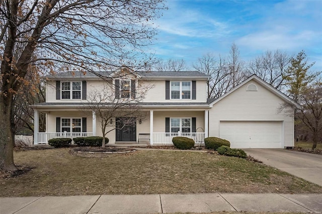 view of property with a porch, a garage, and a front yard