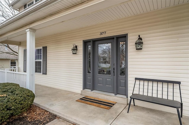 view of exterior entry featuring a porch