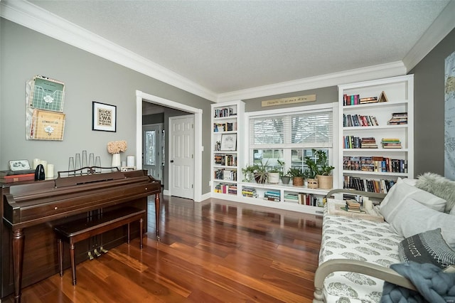 sitting room with crown molding, dark wood-type flooring, and a textured ceiling