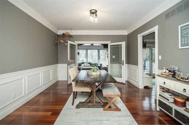 dining room featuring crown molding, a textured ceiling, and dark hardwood / wood-style flooring