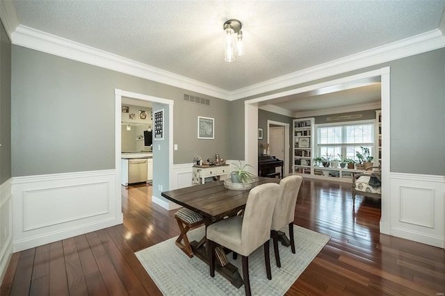 dining room with crown molding, dark hardwood / wood-style flooring, and a textured ceiling