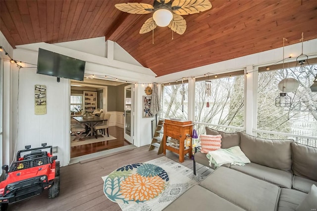 sunroom with vaulted ceiling with beams, wood ceiling, and ceiling fan