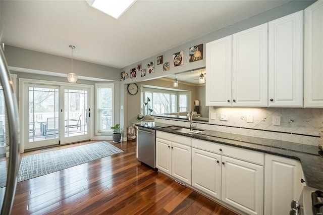 kitchen with stainless steel dishwasher and white cabinets