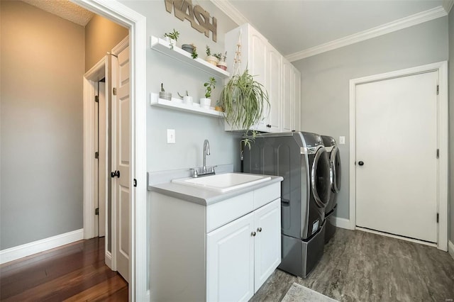 laundry area with independent washer and dryer, ornamental molding, dark hardwood / wood-style floors, and sink