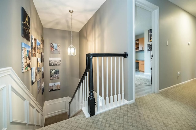 staircase featuring carpet