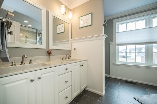 bathroom with vanity, a wealth of natural light, and tile patterned floors