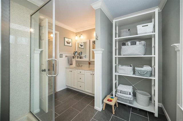 bathroom with ornamental molding, vanity, and a shower with shower door