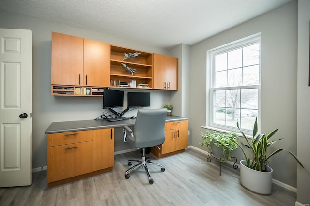 office featuring light hardwood / wood-style floors and a textured ceiling