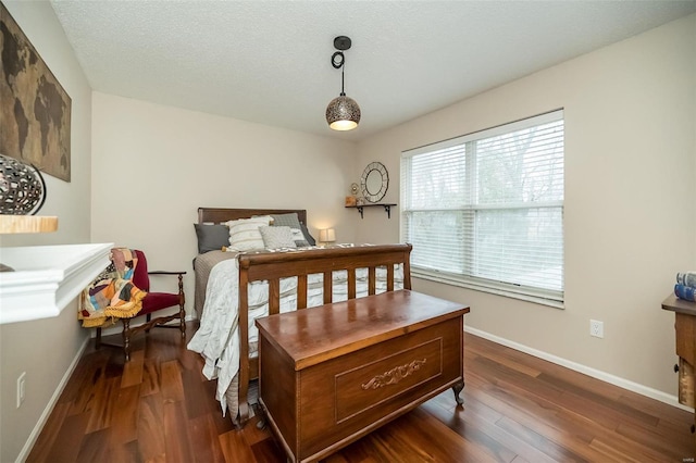 bedroom featuring dark hardwood / wood-style floors and a textured ceiling