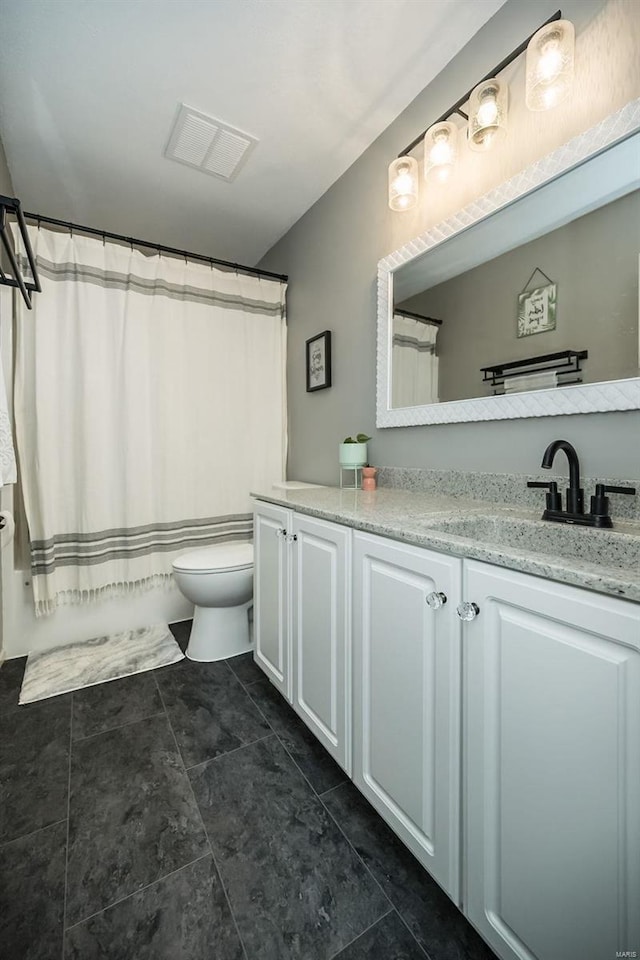 bathroom featuring vanity and toilet