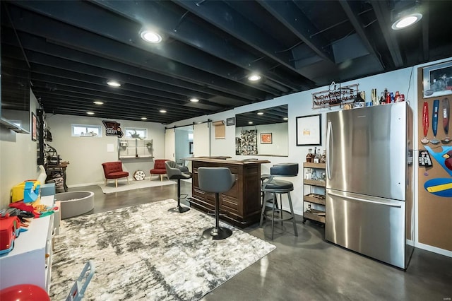 interior space featuring stainless steel fridge and light stone countertops