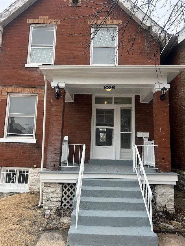 view of exterior entry with covered porch