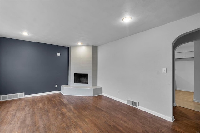 unfurnished living room with hardwood / wood-style flooring and a fireplace