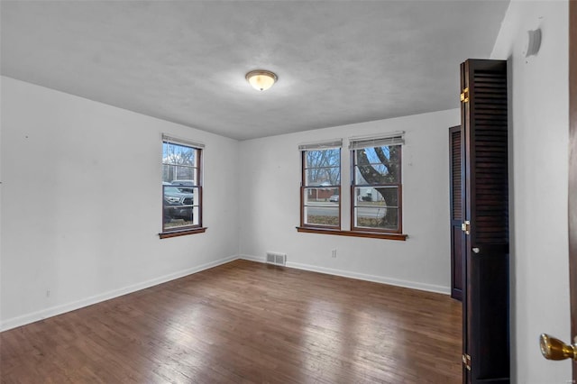 spare room featuring dark hardwood / wood-style flooring