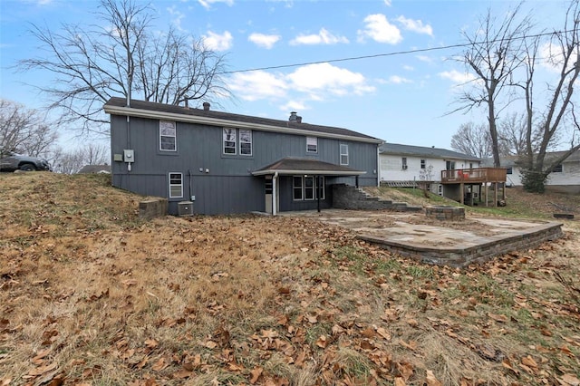 rear view of house with a deck and a patio area