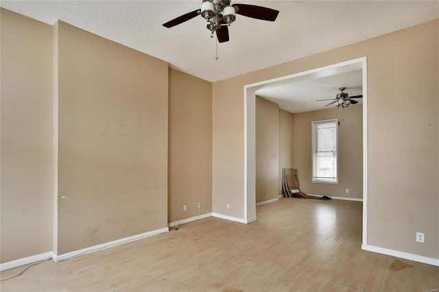 unfurnished room with light hardwood / wood-style floors and a textured ceiling