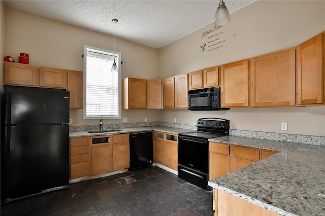 kitchen featuring light stone counters, sink, hanging light fixtures, and black appliances