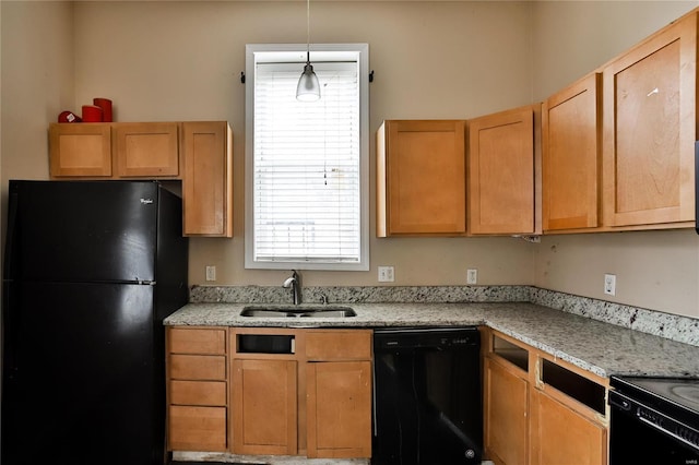 kitchen featuring pendant lighting, light stone countertops, sink, and black appliances