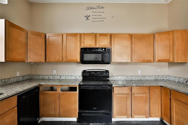 kitchen featuring light stone counters and black appliances