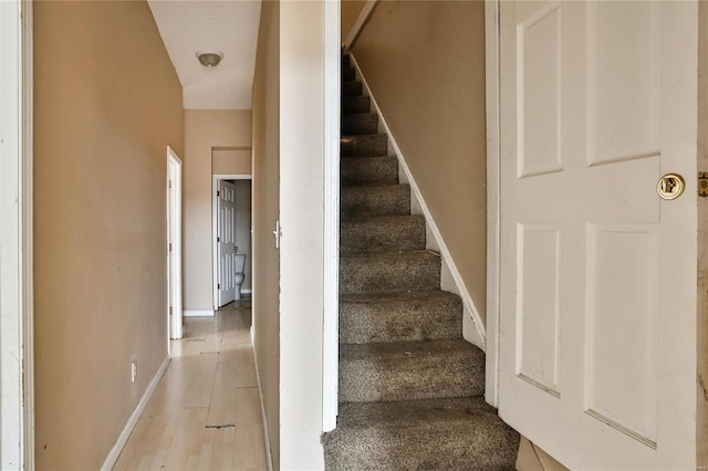 stairs with hardwood / wood-style floors