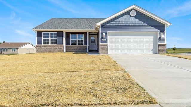 view of front of property featuring a garage and a front yard