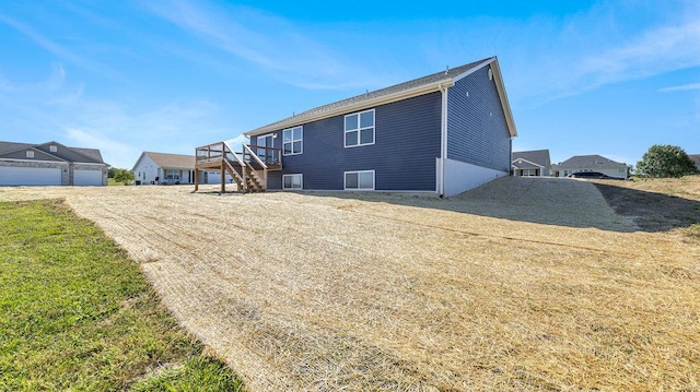 back of house featuring a wooden deck