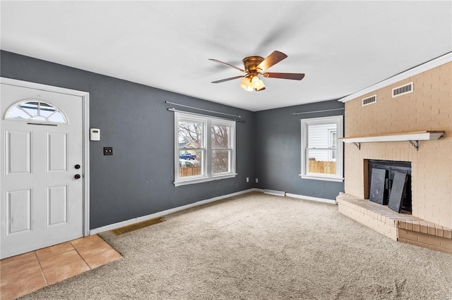 unfurnished living room featuring ceiling fan, carpet floors, and a fireplace